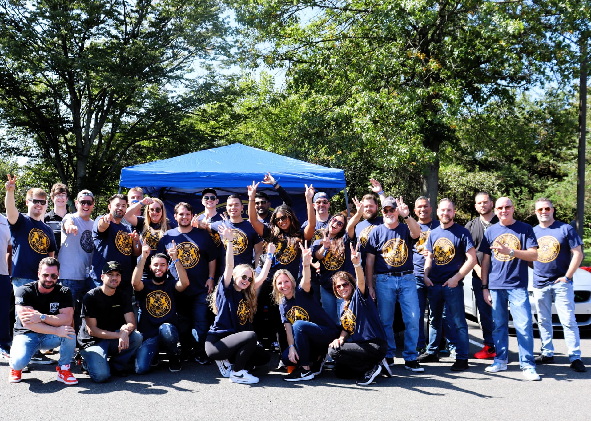 BimToberFest crew in gold crest shirts posing together