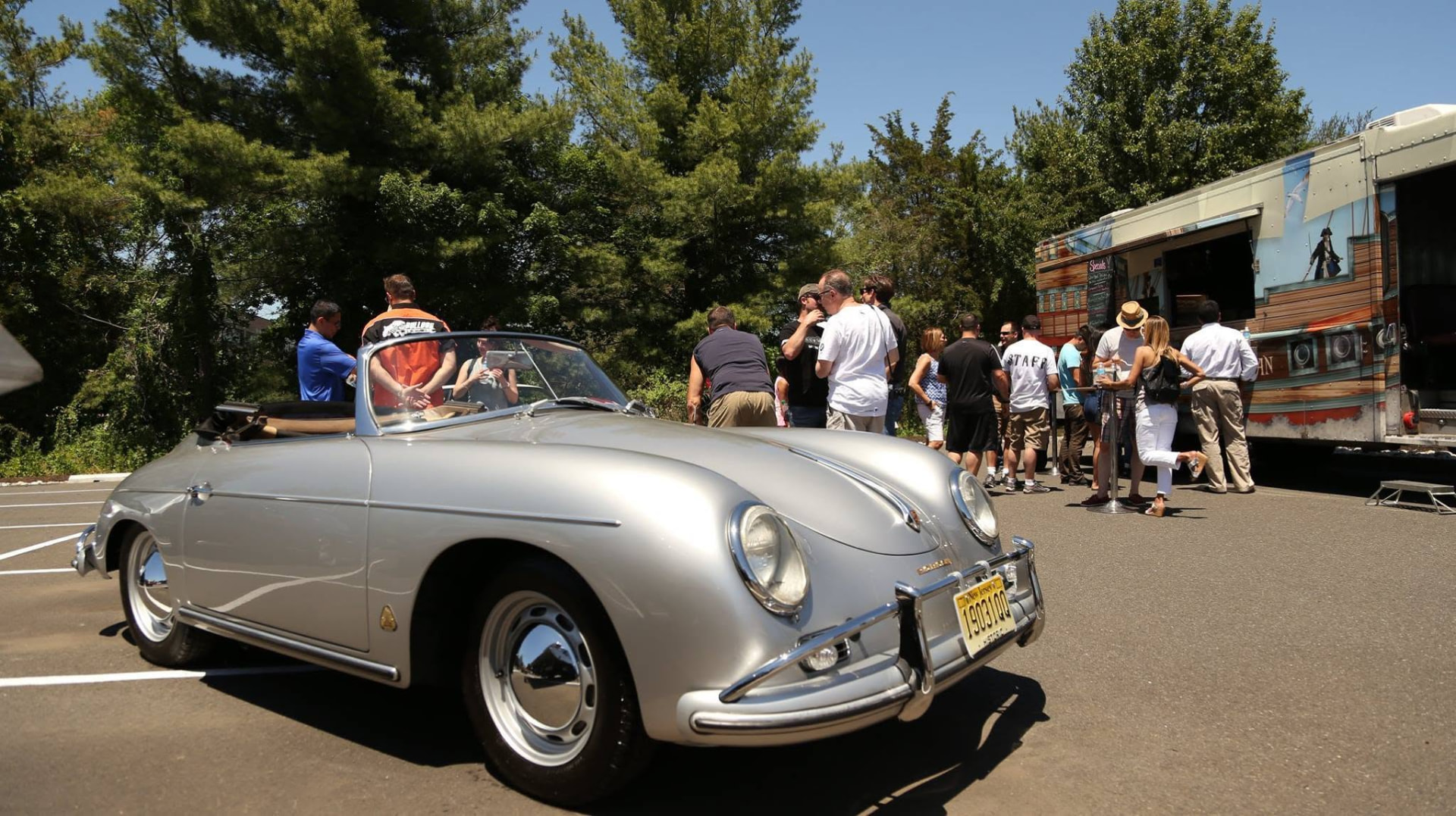 Silver Porsche 356 Speedster parked by a food truck at BimToberFest