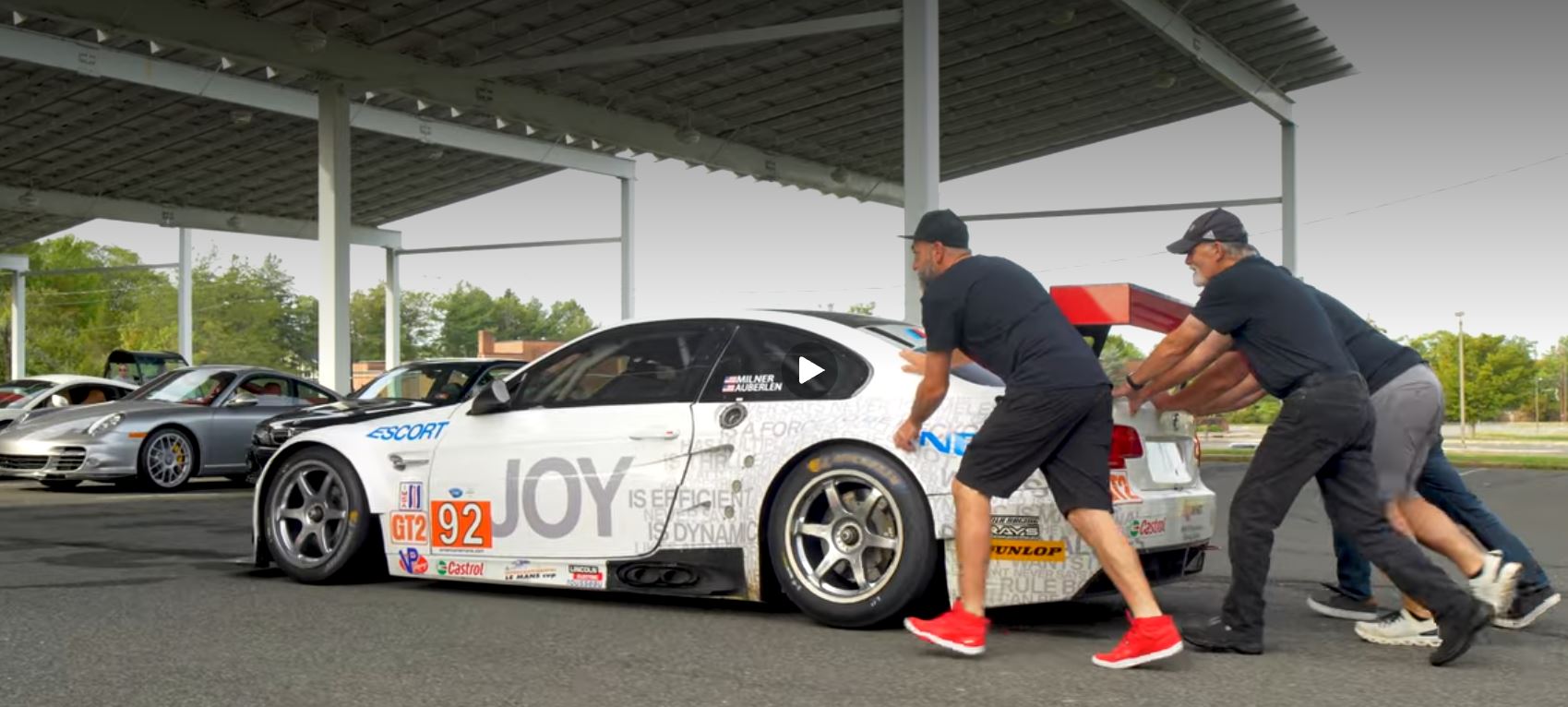 BMW M3 GT2 race car being pushed under the solar canopy