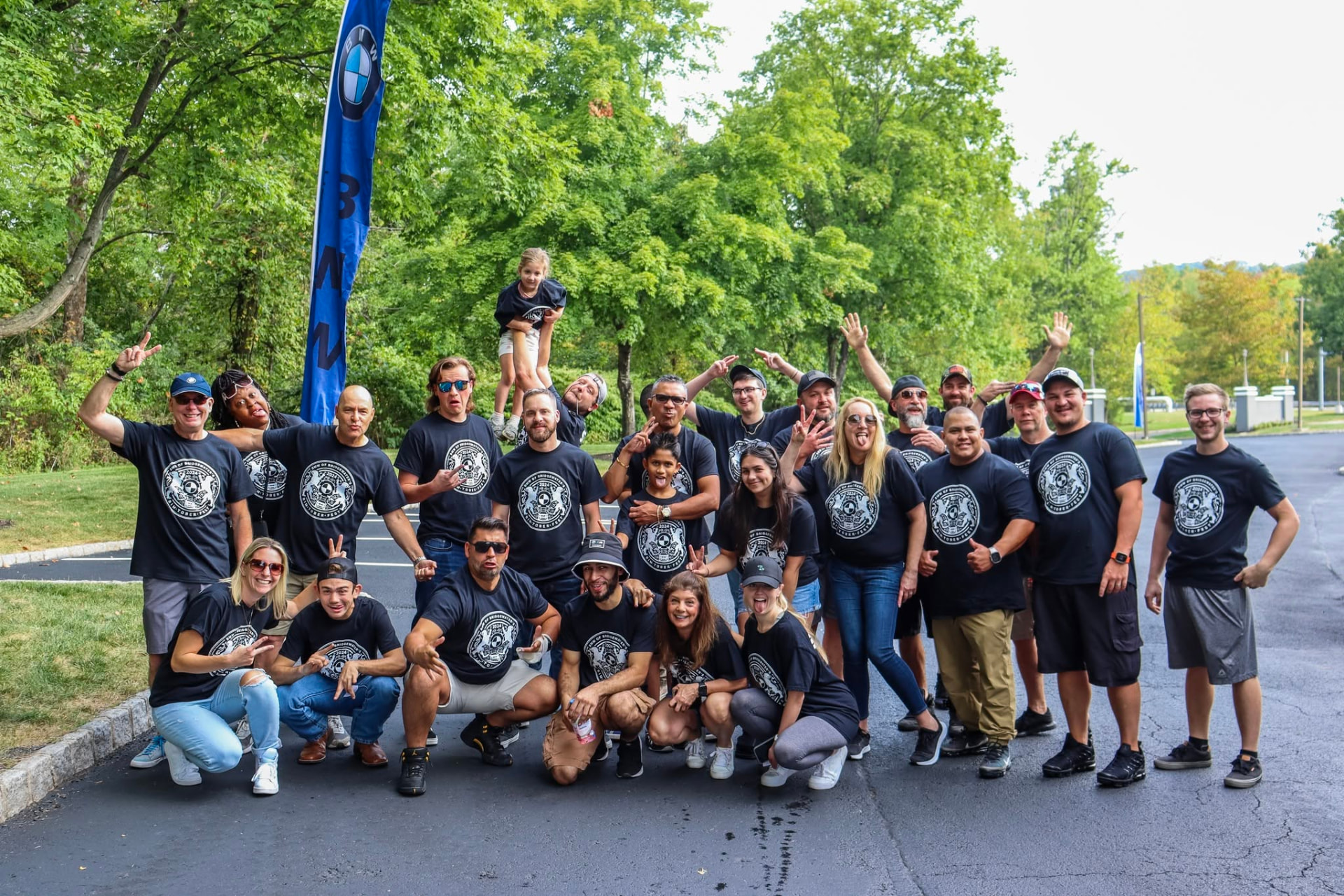 BimToberFest crew group photo under the BMW flag